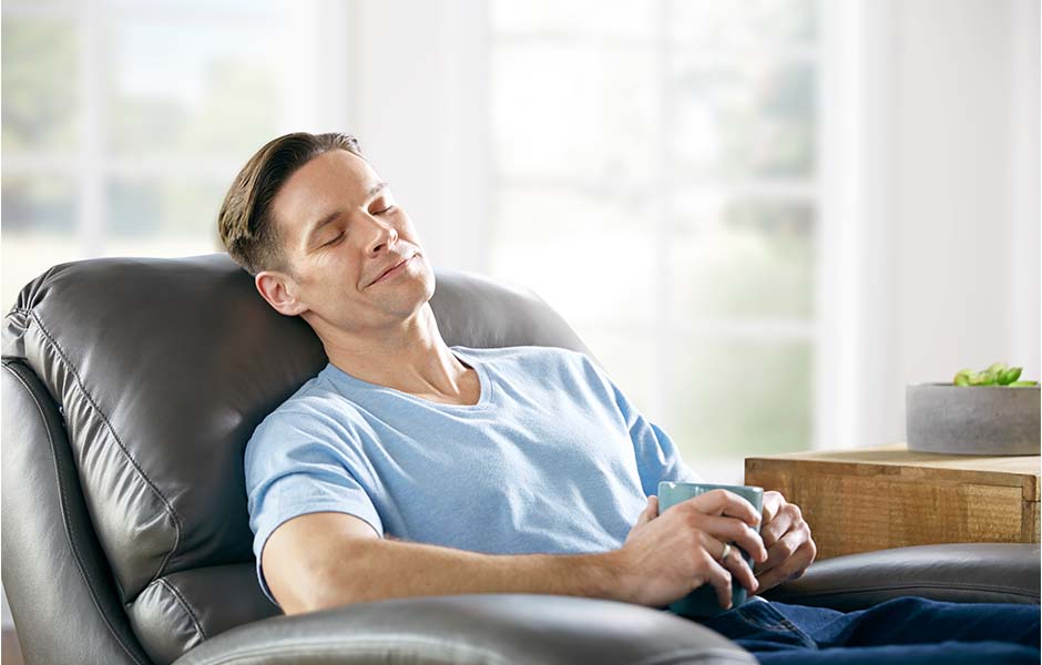 Man relaxing in most comfortable living room chair