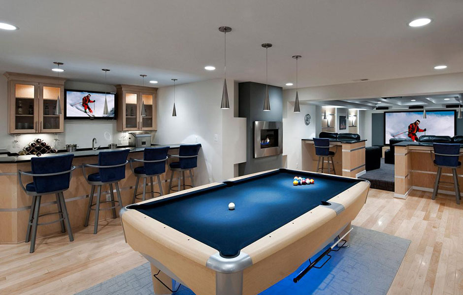 Man cave with kitchen and ample seating, suitable for entertaining.